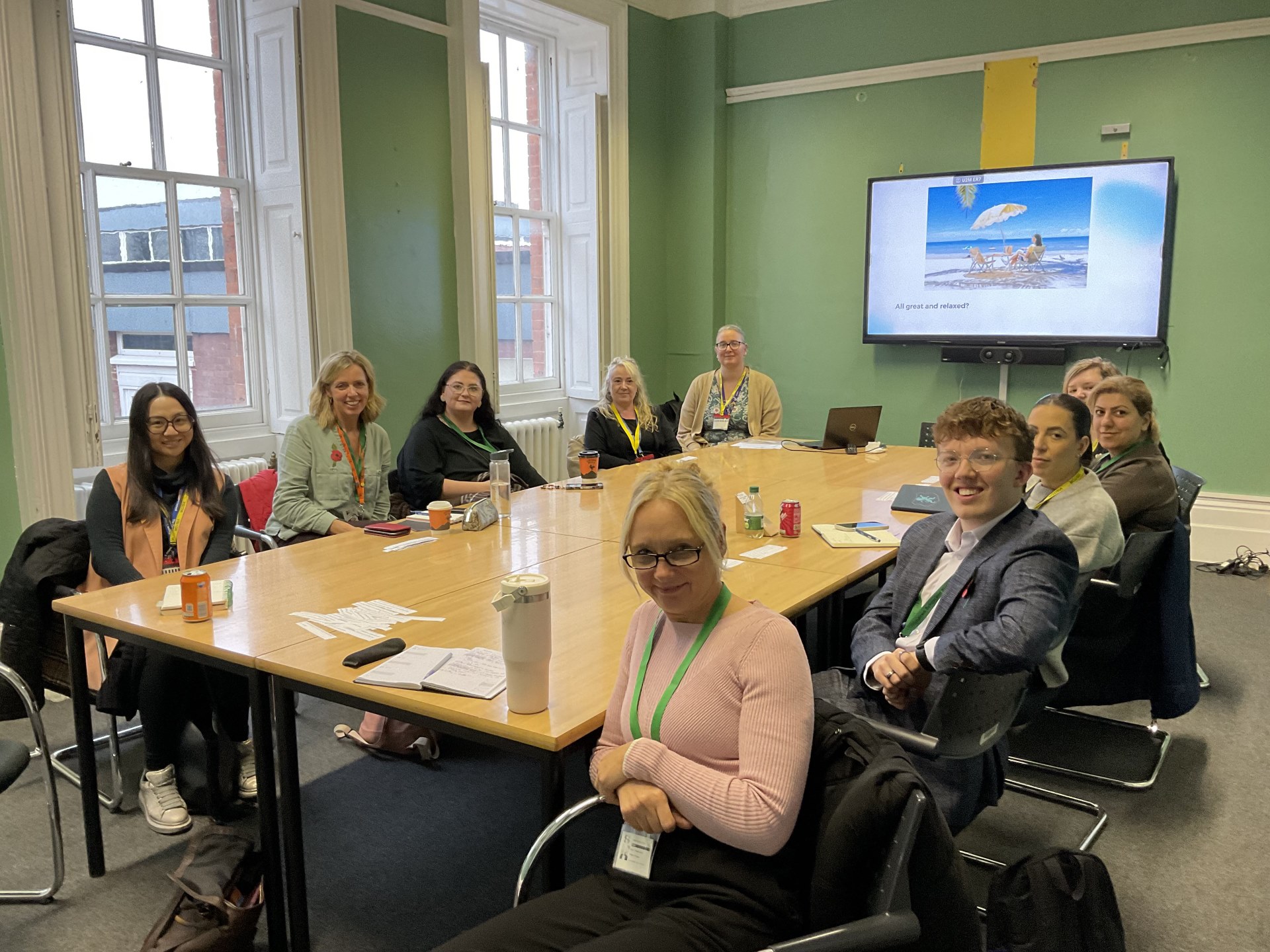 Copy of 10 attendees of the West TA Network sitting round a conference table smiling.jpg